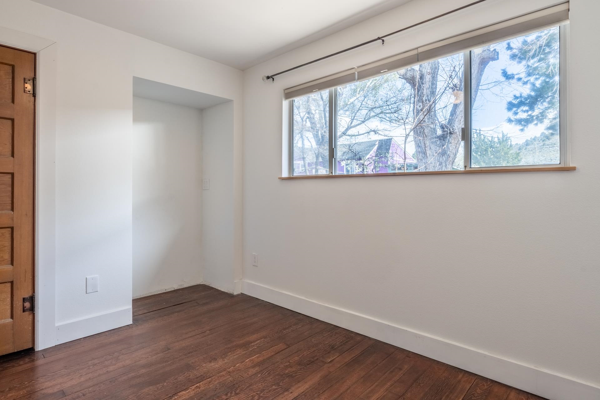91 3rd Street Lee Vining, CA 93541 - Photo 20 of 44 an empty room with wooden floor and windows