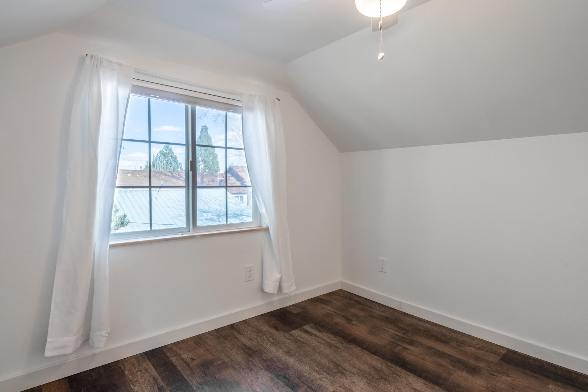 91 3rd Street Lee Vining, CA 93541 - Photo 28 of 44 an empty room with wooden floor and windows