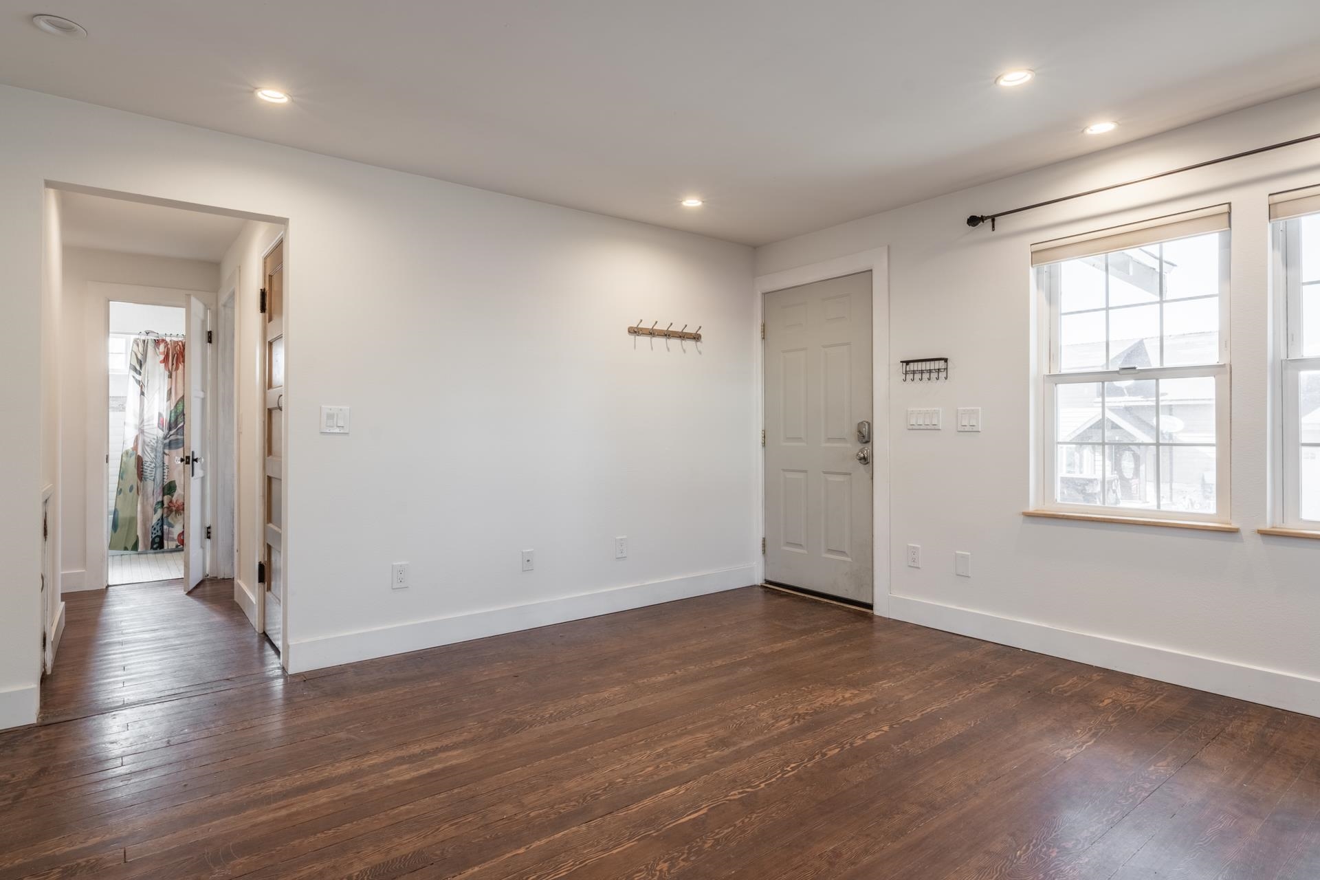 91 3rd Street Lee Vining, CA 93541 - Photo 4 of 44 an empty room with wooden floor and windows