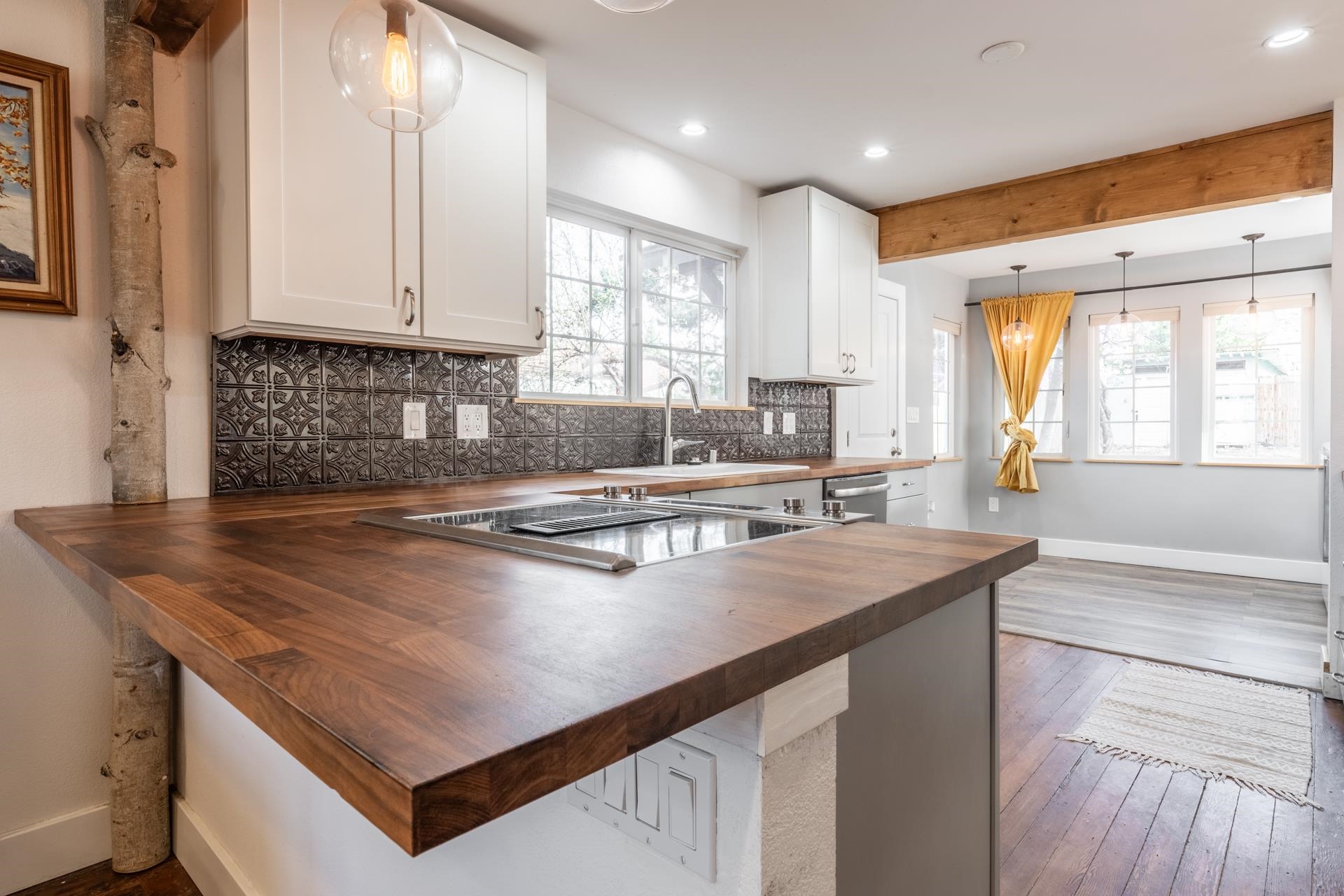 91 3rd Street Lee Vining, CA 93541 - Photo 8 of 44 a kitchen with stainless steel appliances granite countertop a sink a stove and a microwave