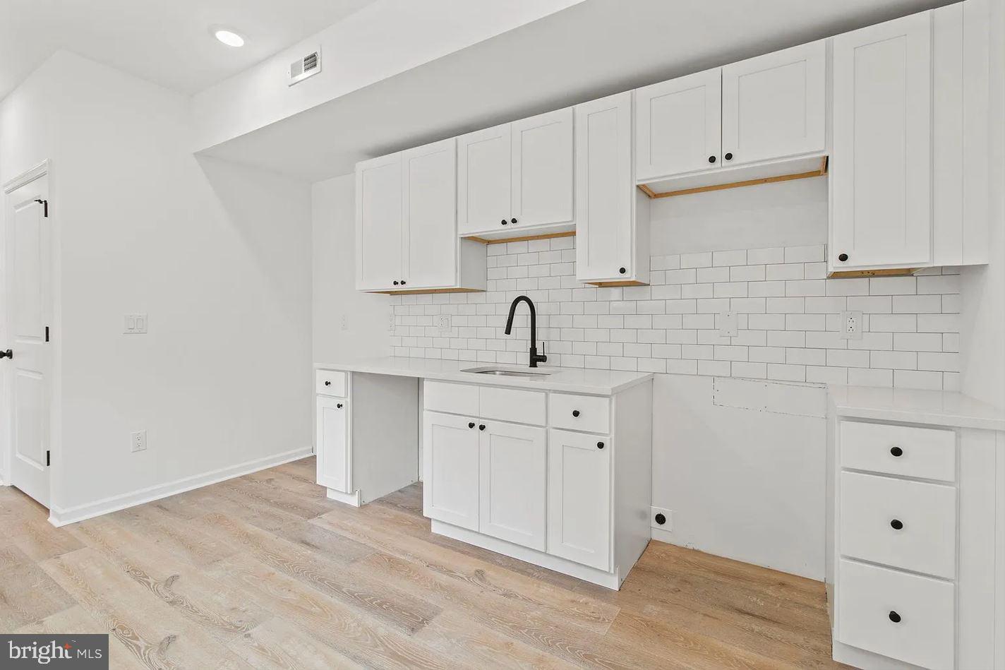 5225 Walnut Street, Unit 4 Philadelphia, PA 19139 - Photo 2 of 11 a view of a kitchen with white cabinets
