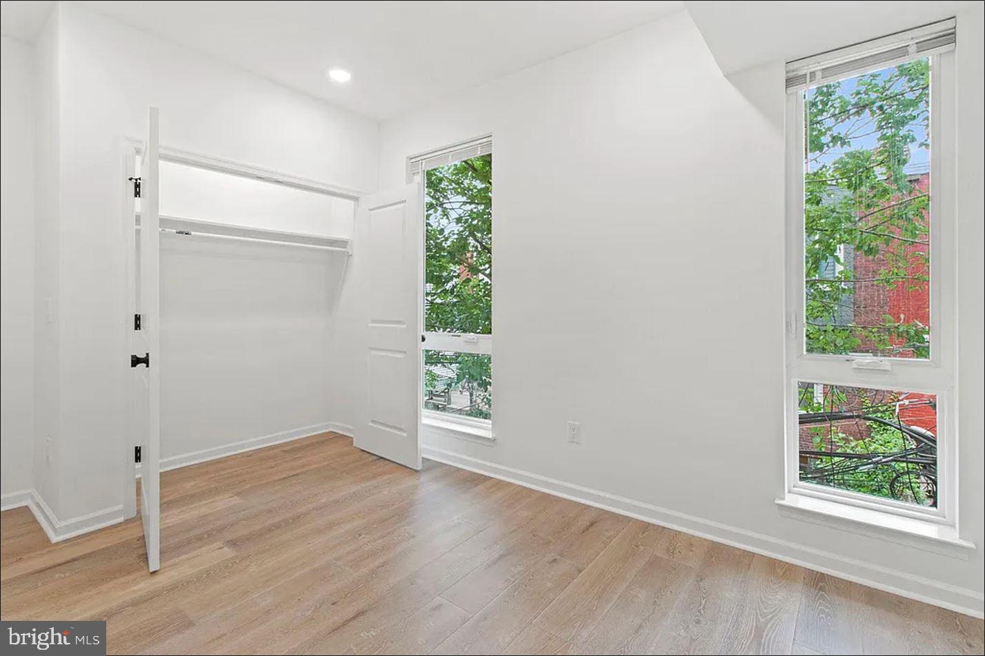 5225 Walnut Street, Unit 4 Philadelphia, PA 19139 - Photo 4 of 11 an empty room with wooden floor and windows