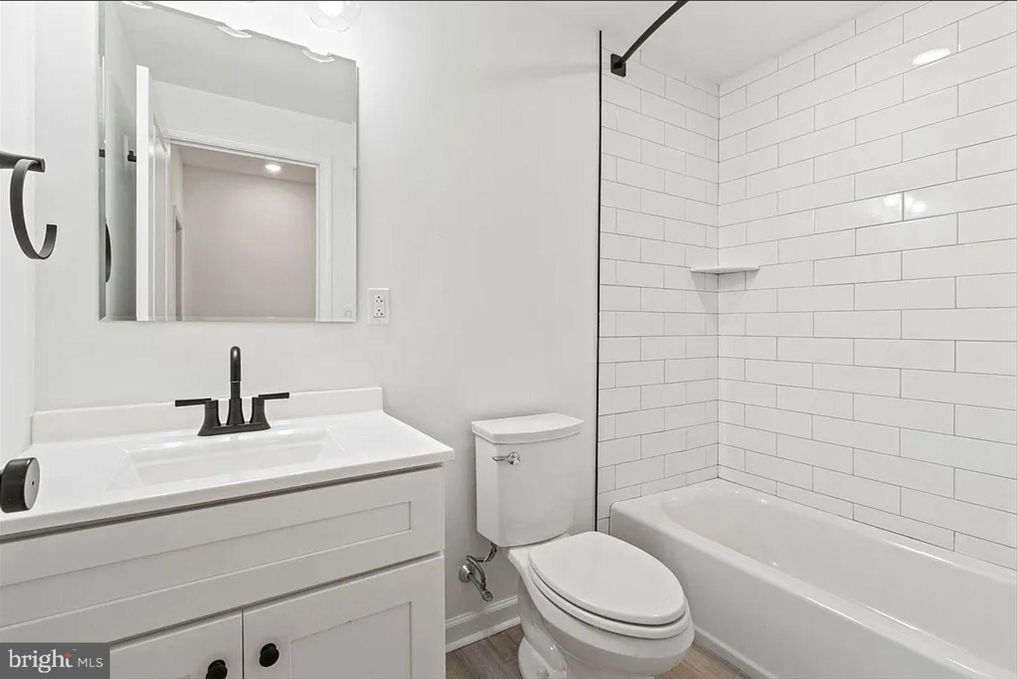 5225 Walnut Street, Unit 4 Philadelphia, PA 19139 - Photo 7 of 11 a bathroom with a sink a toilet and shower