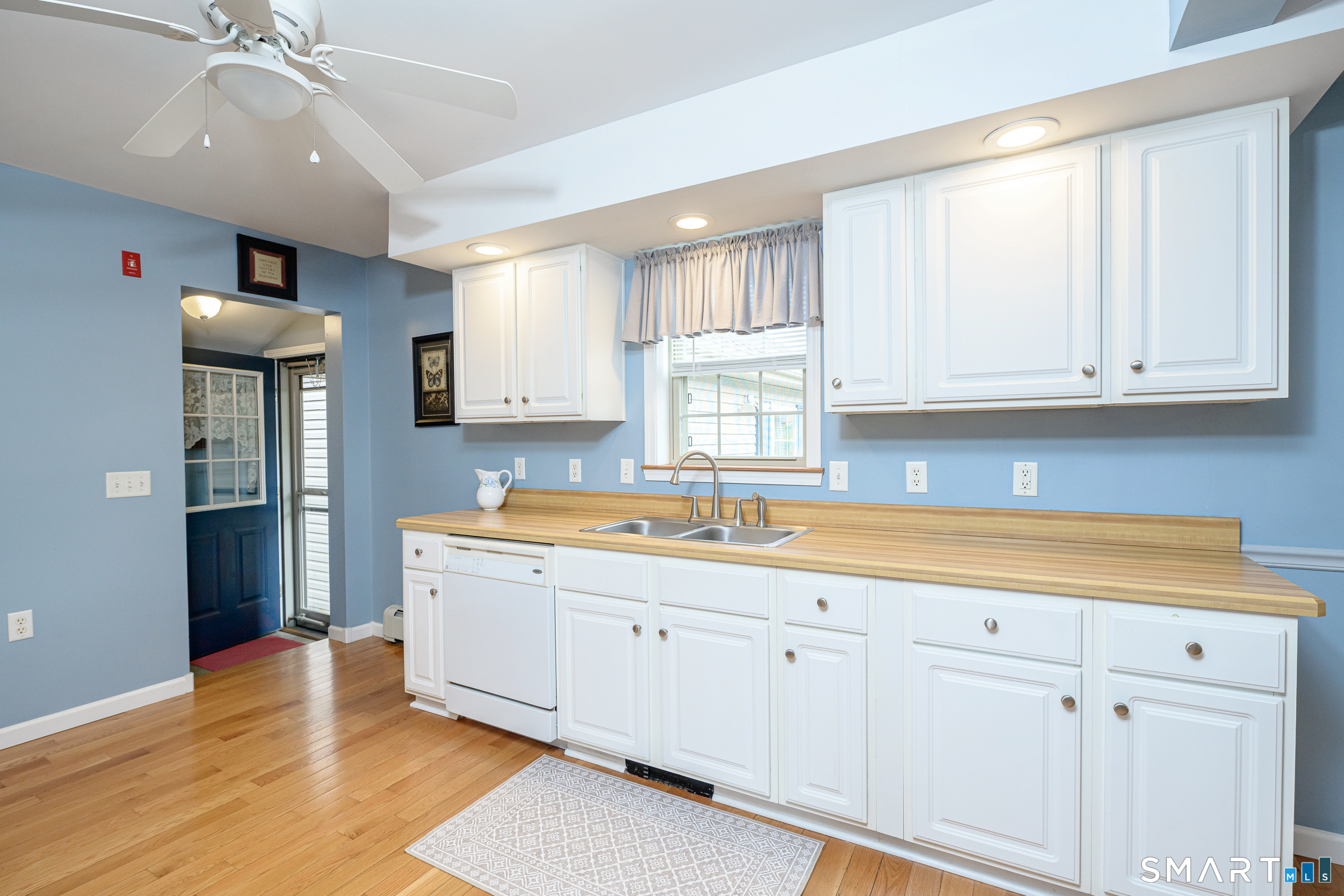 3 Oriole Drive, Unit 3 Killingly, CT 06239 - Photo 8 of 29 a kitchen with granite countertop white cabinets and white appliances