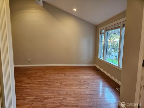 a view of room with window and wooden floor
