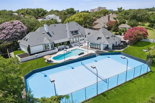 an aerial view of a house with a garden and trees