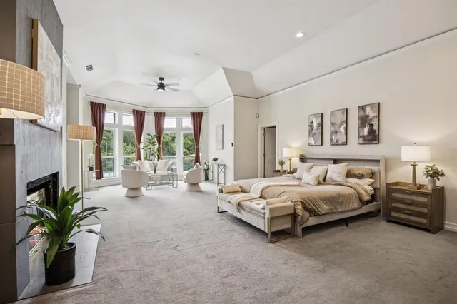 a spacious bedroom with a bed and a fireplace