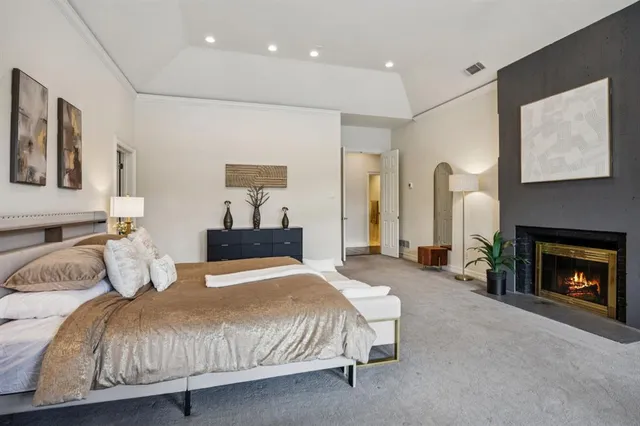 a bedroom with a bed and a fireplace