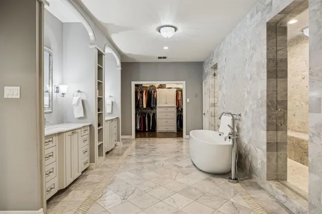 a spacious bathroom with a double vanity sink mirror and shower
