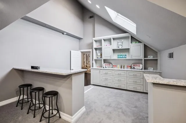 a kitchen with stainless steel appliances cabinets and a table