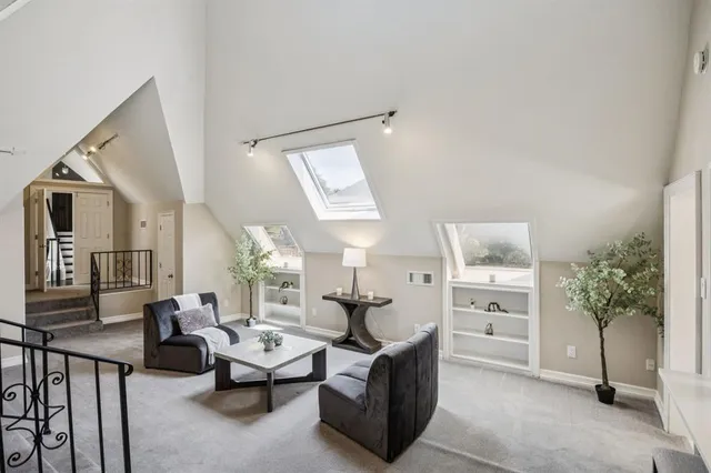 a living room with furniture and view of kitchen