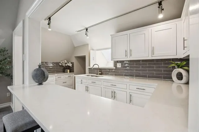 a kitchen with a sink a stove and cabinets