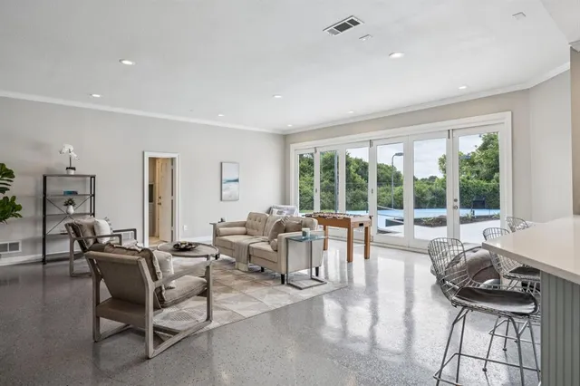 a living room with furniture and large windows