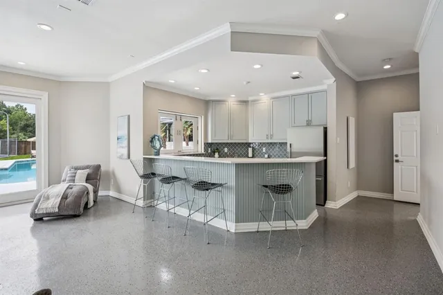 a kitchen with stainless steel appliances granite countertop a sink and a refrigerator
