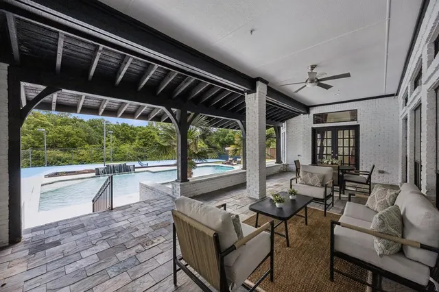 a living room with furniture and large windows