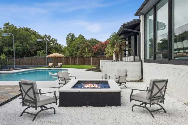 a view of a patio with couches table and chairs and potted plants