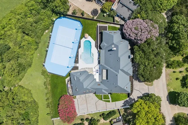 an aerial view of a house with outdoor space and a lake view