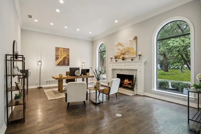a living room with furniture a fireplace and a floor to ceiling window