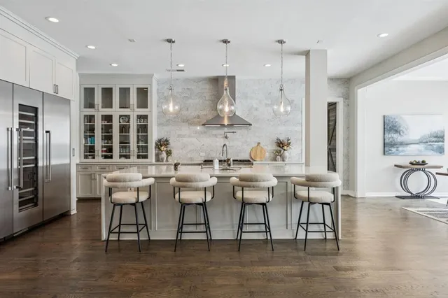 a kitchen with stainless steel appliances kitchen island granite countertop a sink and cabinets