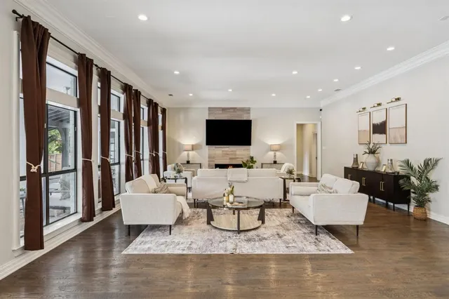 a living room with fireplace furniture and a flat screen tv