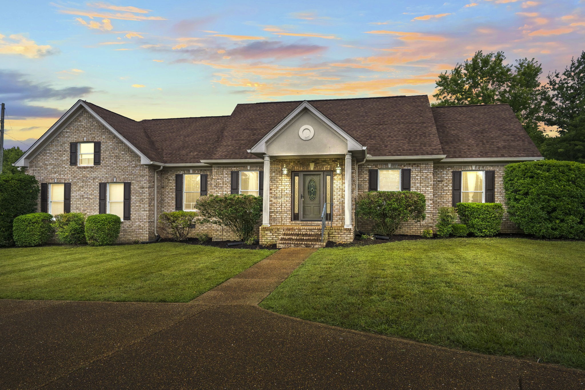 a front view of a house with a garden
