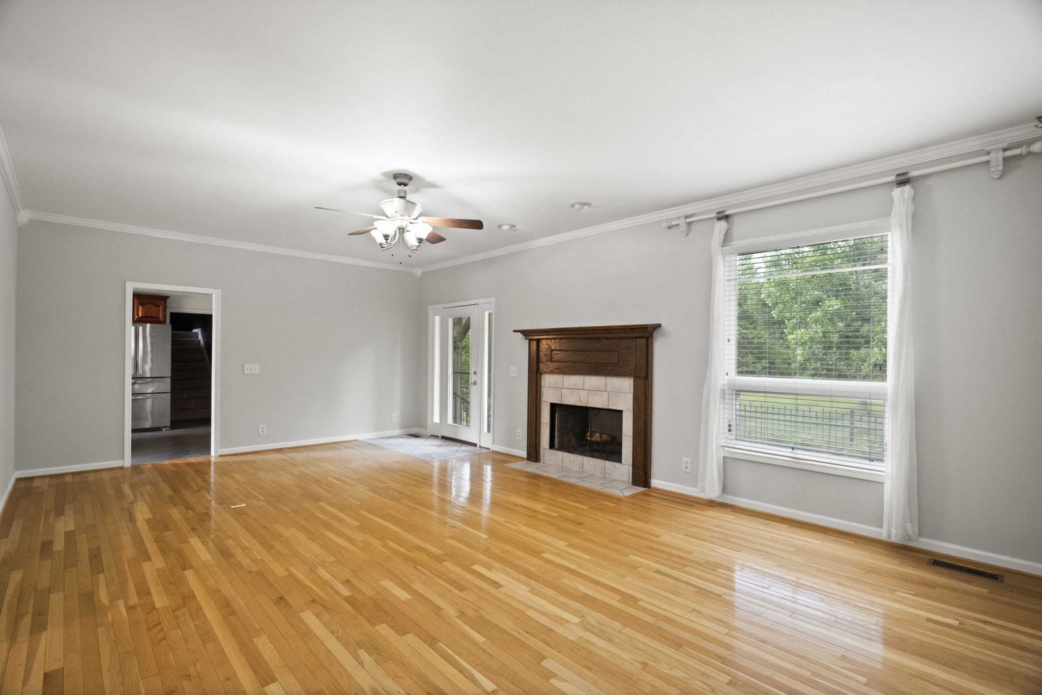 7144 Bidwell Road Joelton, TN 37080 - Photo 12 of 60 a view of an empty room with wooden floor fireplace and a window