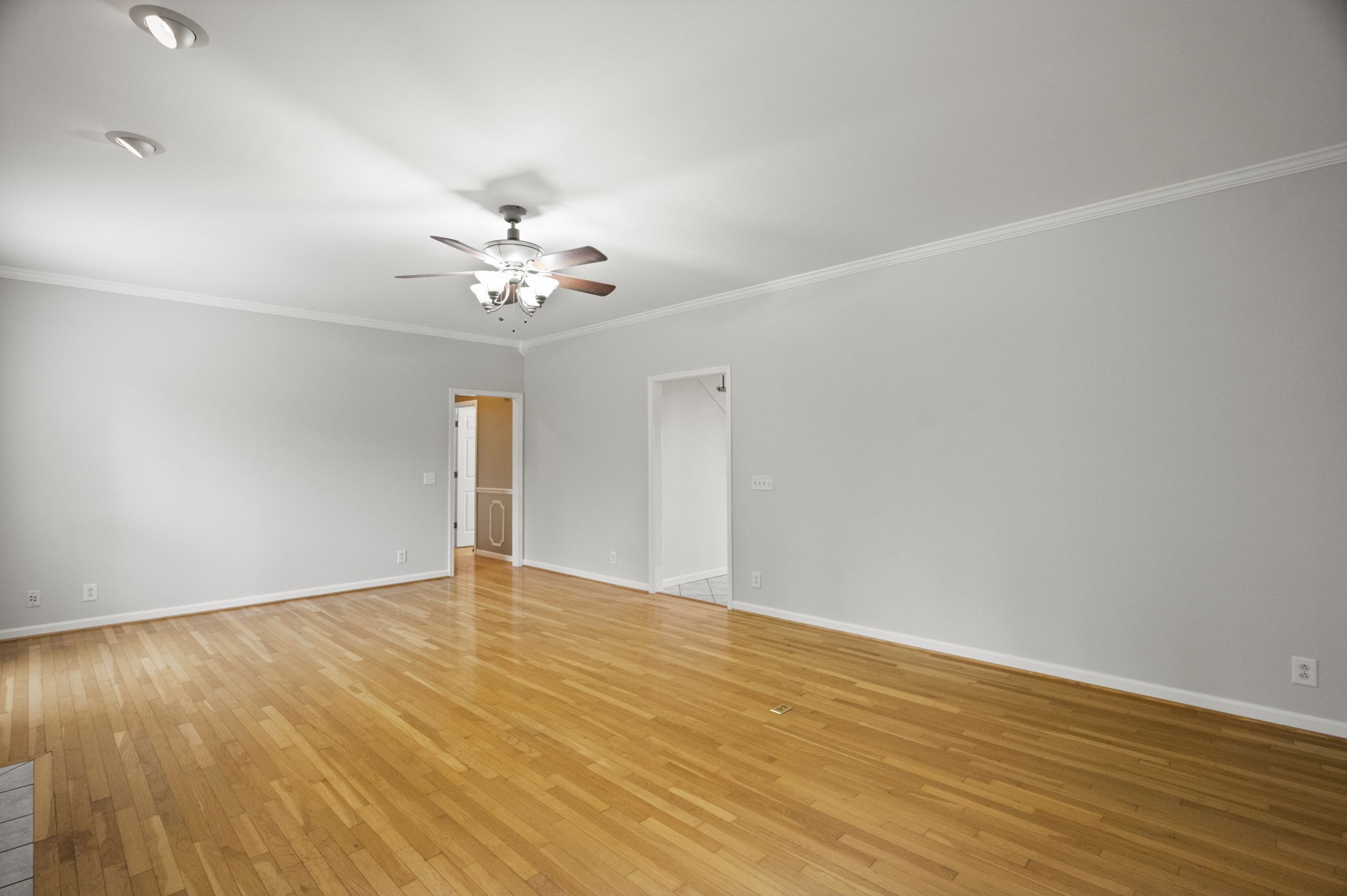 7144 Bidwell Road Joelton, TN 37080 - Photo 20 of 60 a view of an empty room with chandelier fan and wooden floor