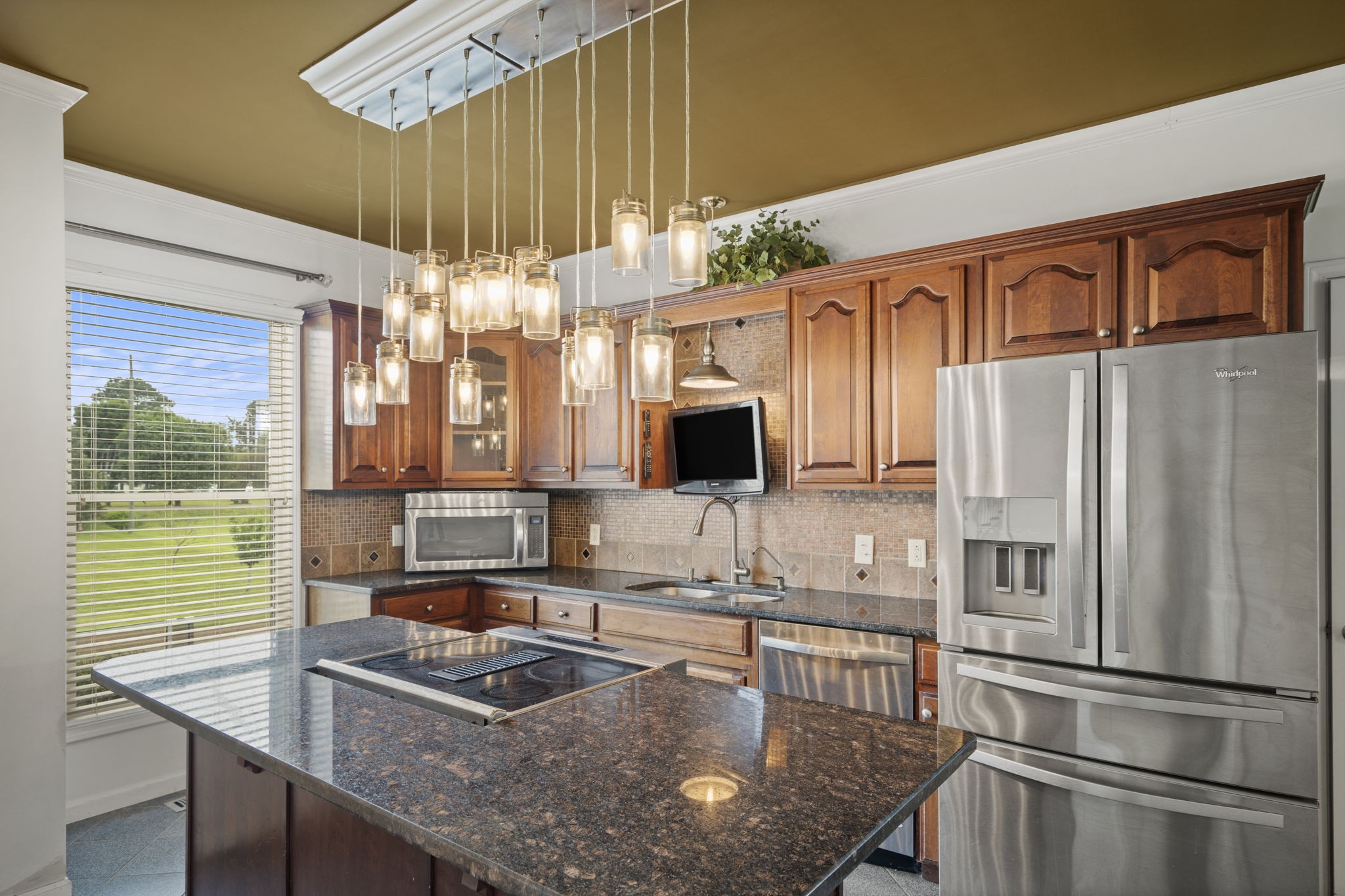 7144 Bidwell Road Joelton, TN 37080 - Photo 27 of 60 a kitchen with kitchen island granite countertop a sink refrigerator and microwave