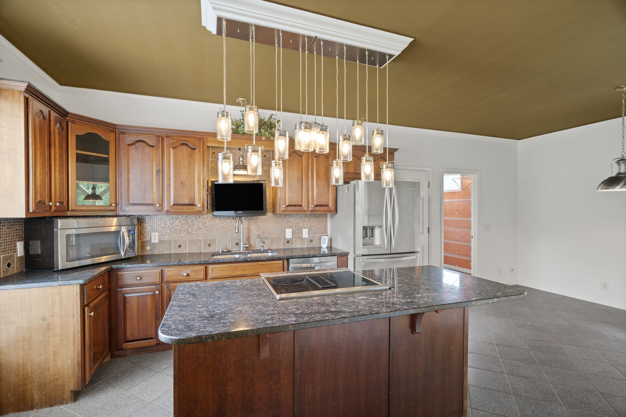 7144 Bidwell Road Joelton, TN 37080 - Photo 28 of 60 a kitchen with granite countertop a sink a stove and cabinets