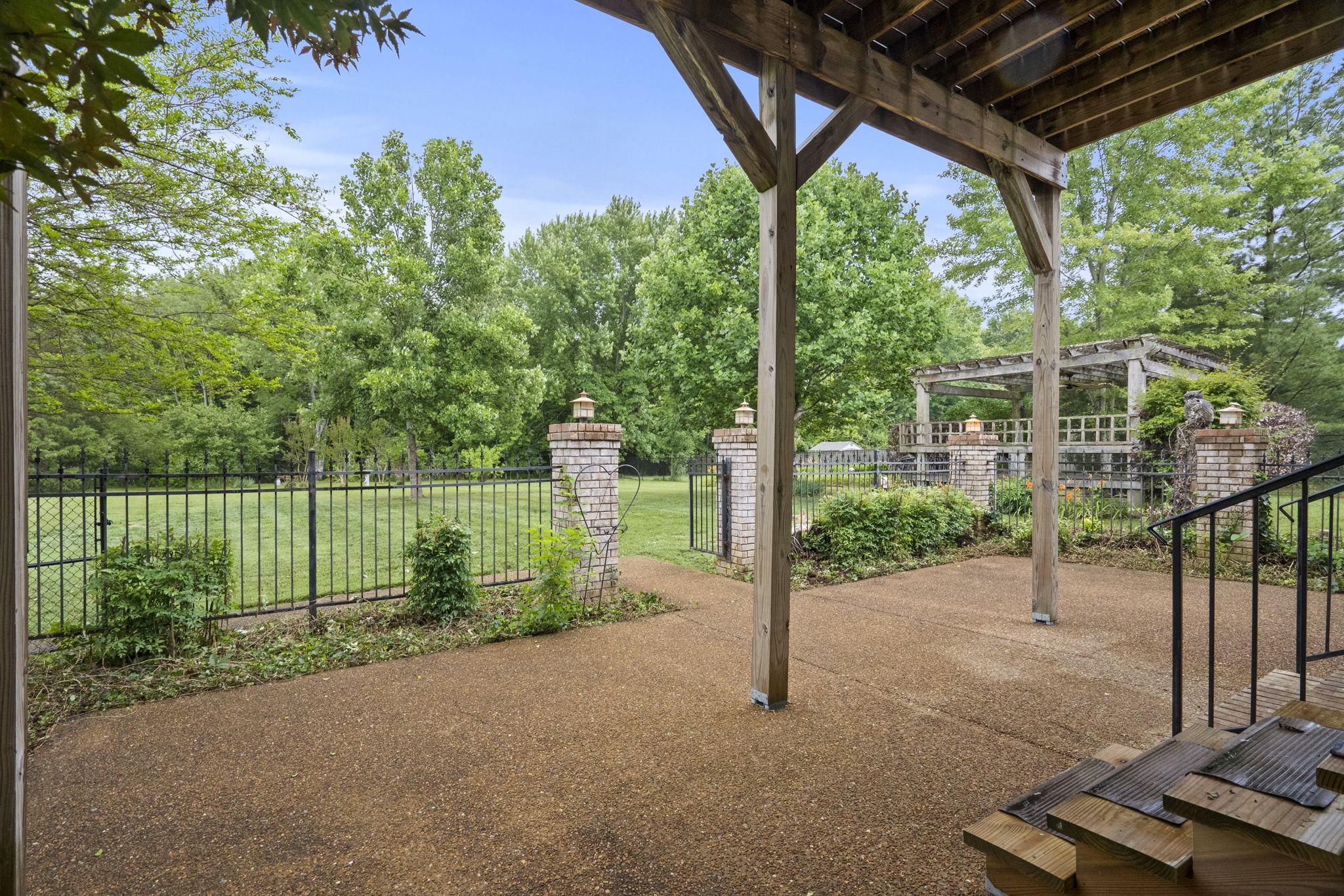 7144 Bidwell Road Joelton, TN 37080 - Photo 51 of 60 a view of a backyard with floor to ceiling window and wooden fence