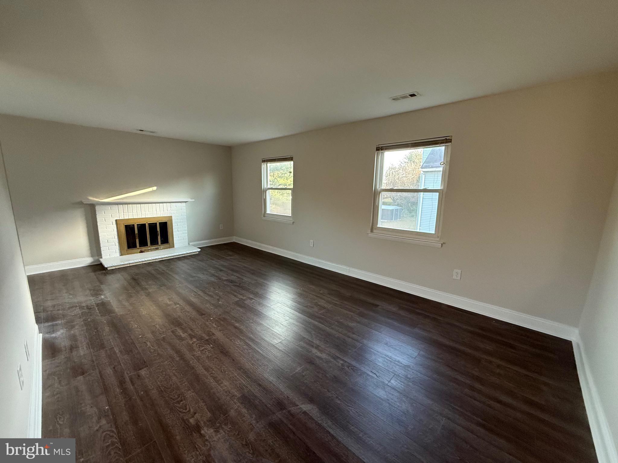 162 Willow Turn, Unit B Mount Laurel, NJ 08054 - Photo 2 of 12 a view of an empty room with wooden floor and a window