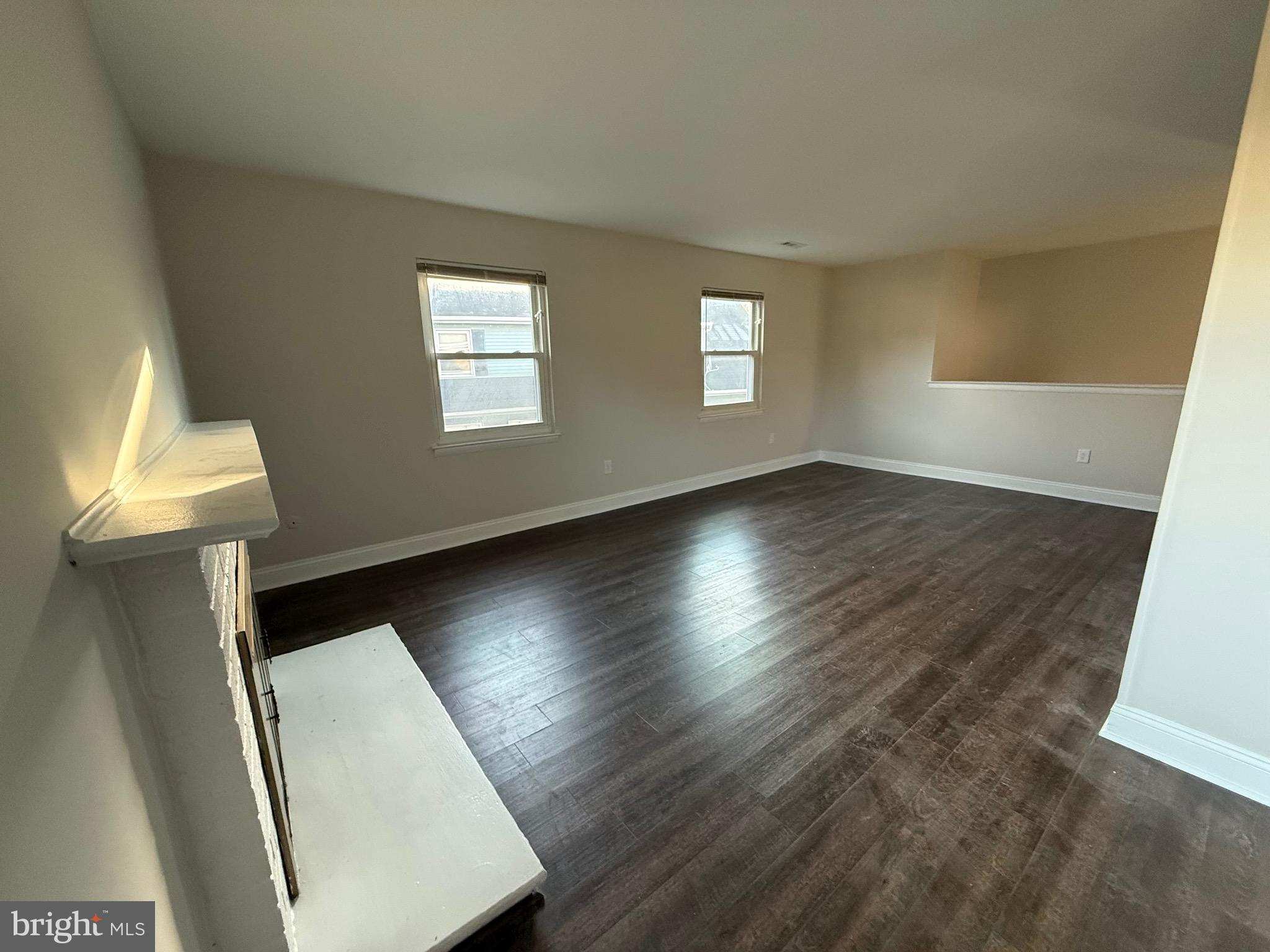 162 Willow Turn, Unit B Mount Laurel, NJ 08054 - Photo 6 of 12 a view of an empty room with wooden floor and a window
