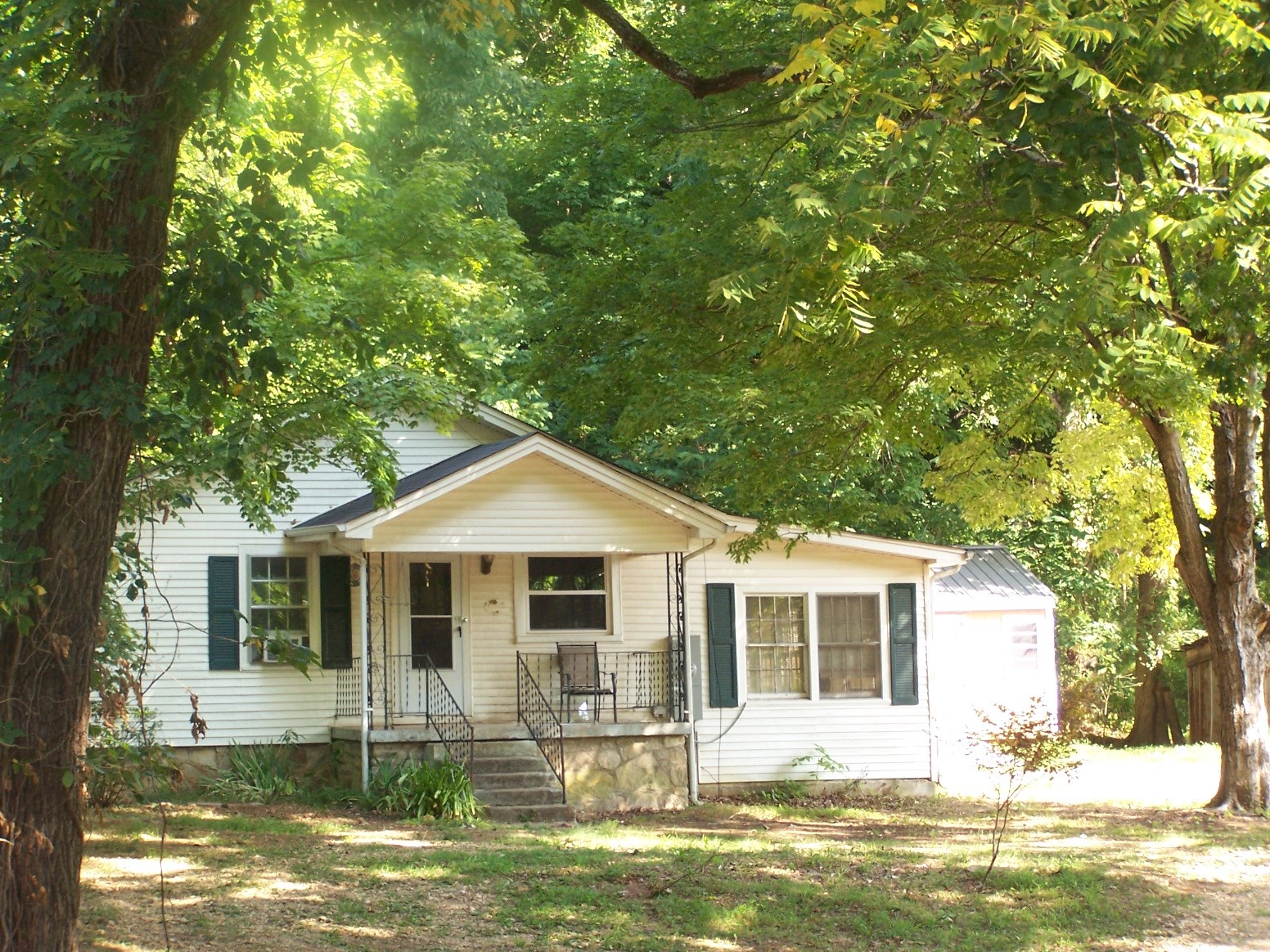 1346 Garner Hollow Road Pulaski, TN 38478 - Photo 10 of 42 a front view of a house with a yard table and chairs