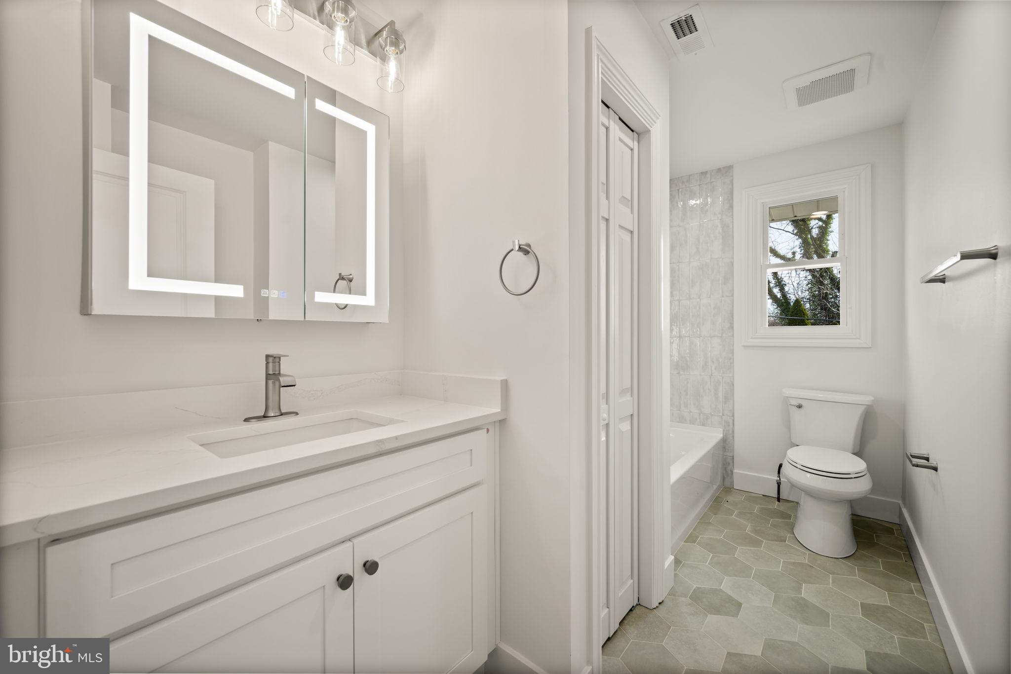 2111 Eastridge Road Lutherville-Timonium, MD 21093 - Photo 14 of 44 a bathroom with a toilet sink and mirror