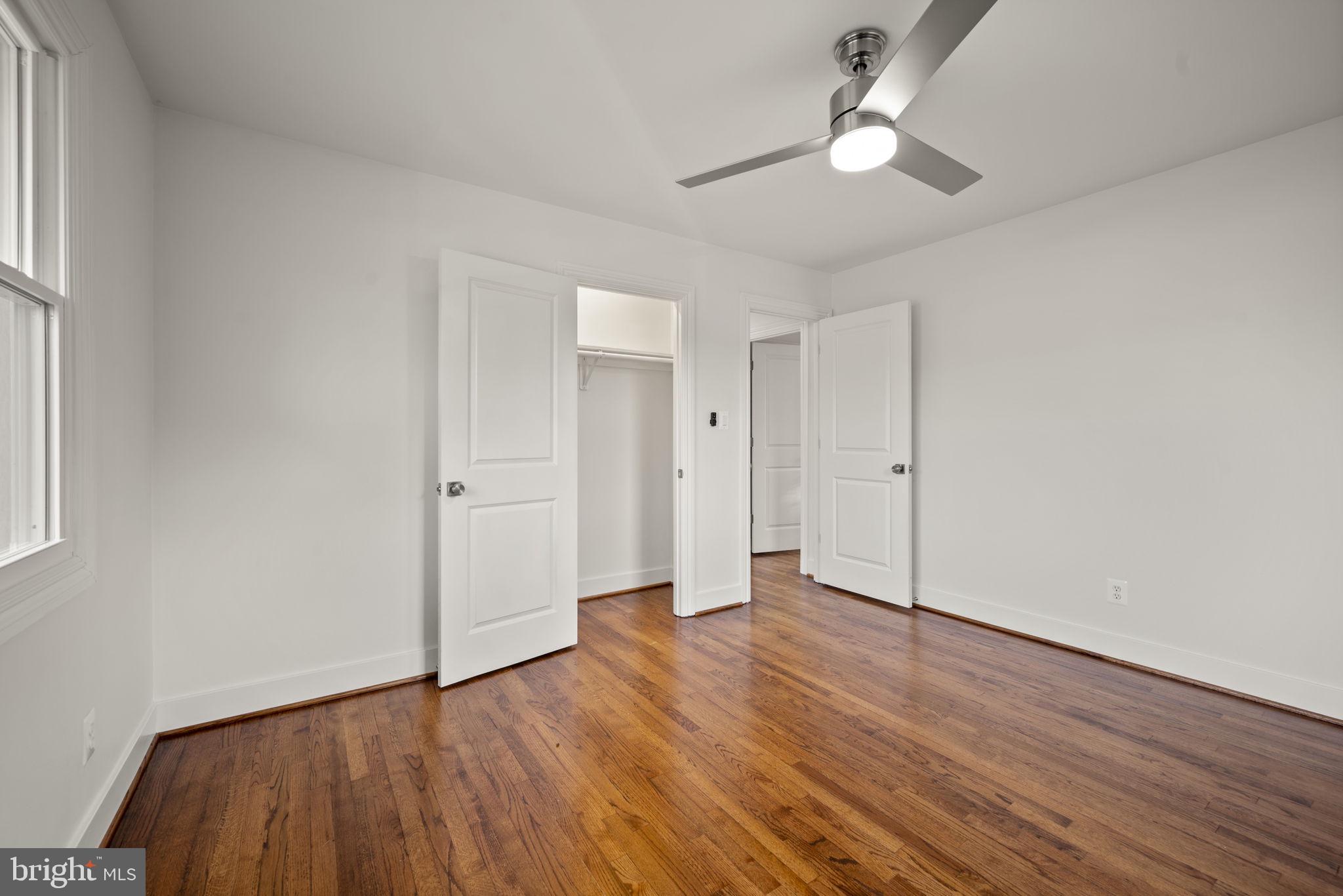 2111 Eastridge Road Lutherville-Timonium, MD 21093 - Photo 17 of 44 an empty room with wooden floor ceiling fan and window