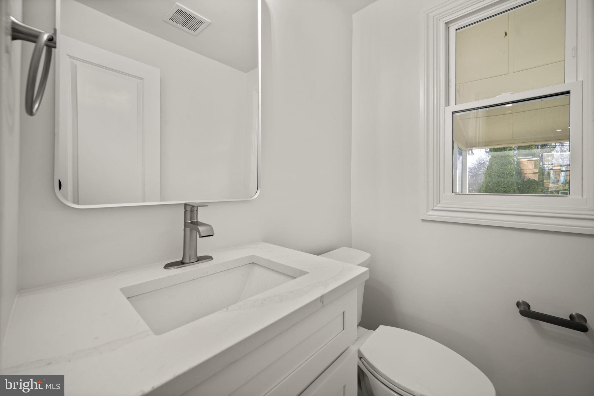 2111 Eastridge Road Lutherville-Timonium, MD 21093 - Photo 24 of 44 a bathroom with a toilet sink and mirror