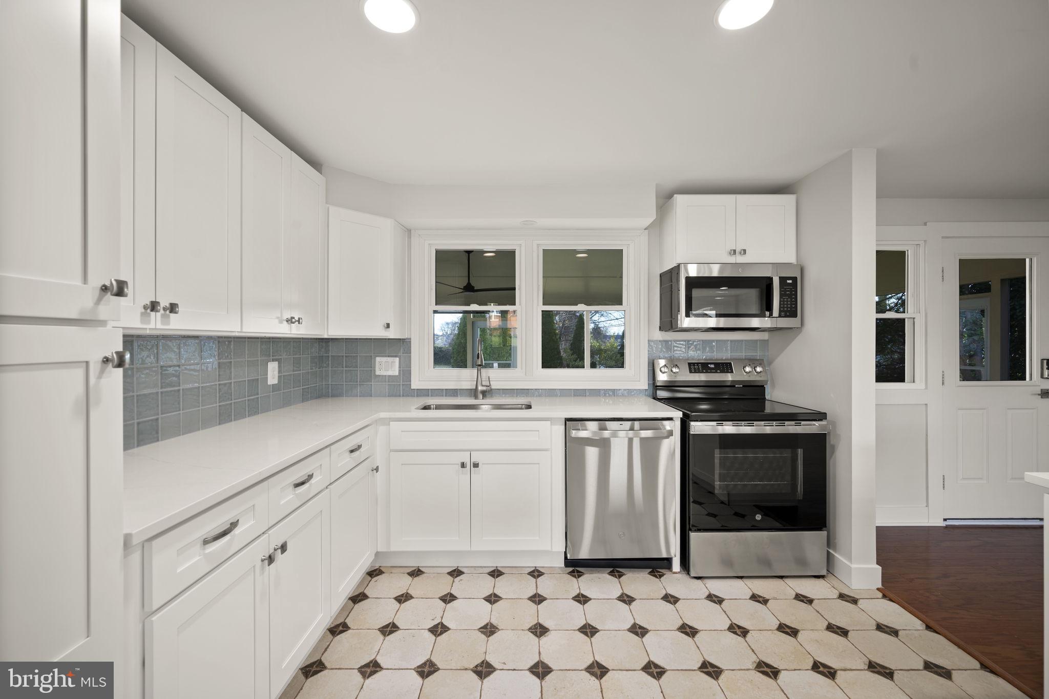 2111 Eastridge Road Lutherville-Timonium, MD 21093 - Photo 6 of 44 a kitchen with stainless steel appliances a stove a sink a stove a microwave and cabinets