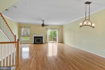 312 Blenny Lane Chester, MD 21619 - Photo 14 of 44 a view of an empty room with wooden floor fireplace and a window