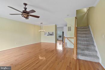 312 Blenny Lane Chester, MD 21619 - Photo 15 of 44 a view of a livingroom with wooden floor and a ceiling fan