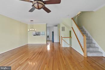312 Blenny Lane Chester, MD 21619 - Photo 16 of 44 a view of a hallway with wooden floor and staircase