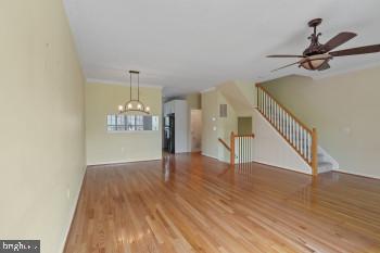 312 Blenny Lane Chester, MD 21619 - Photo 17 of 44 a view of a room with wooden floor staircase and a chandelier