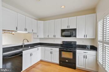 312 Blenny Lane Chester, MD 21619 - Photo 20 of 44 a kitchen with granite countertop white cabinets and stainless steel appliances