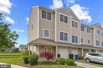 312 Blenny Lane Chester, MD 21619 - Photo 2 of 44 a front view of a residential apartment building with a yard