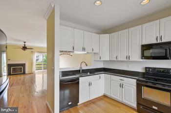 312 Blenny Lane Chester, MD 21619 - Photo 22 of 44 a kitchen with granite countertop a sink a stove and cabinets