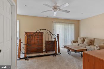 312 Blenny Lane Chester, MD 21619 - Photo 38 of 44 a living room with furniture and a chandelier