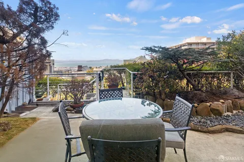 a view of a chairs and table in the patio