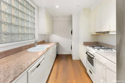 a kitchen with a sink stove and refrigerator