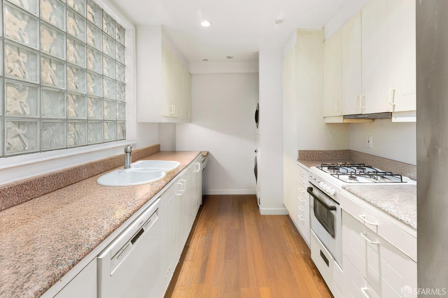2040 Broadway, Unit 102 San Francisco, CA 94115 - Photo 7 of 16 a kitchen with a sink stove and refrigerator