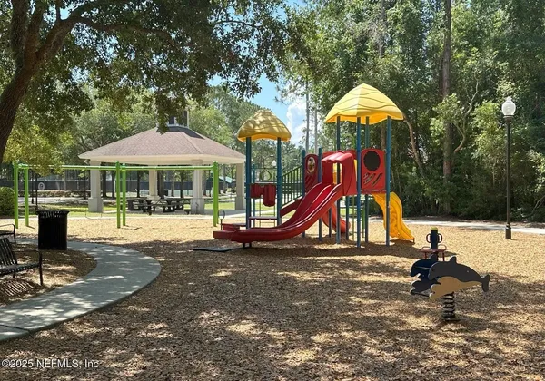 a view of a playground with a slide and swing