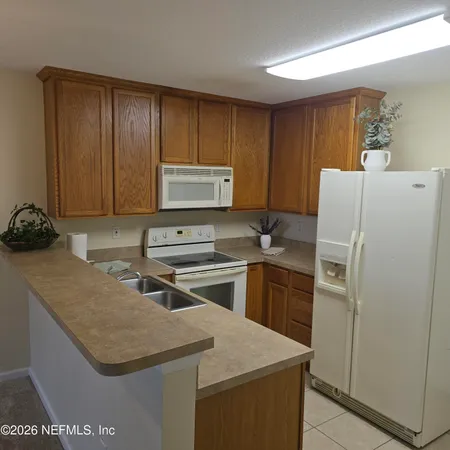 a kitchen with a sink a stove and a refrigerator